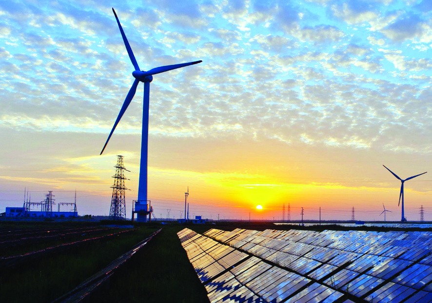 Solar PV panels and wind turbines at sunset